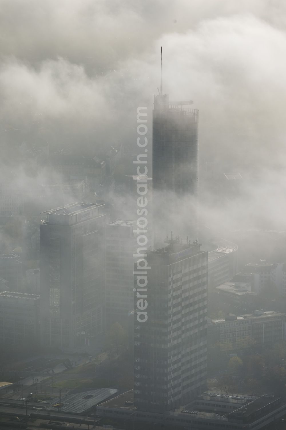 Aerial image Essen - View of the RWE tower shrouded with fog and an impressive cloud bank over the city center of Essen in the state North Rhine-Westphalia. The autumn weather clouds are surrounding the skyscraper headquarters of energy supplier RWE at Opernplatz and form a thick cover over the Ruhr region city