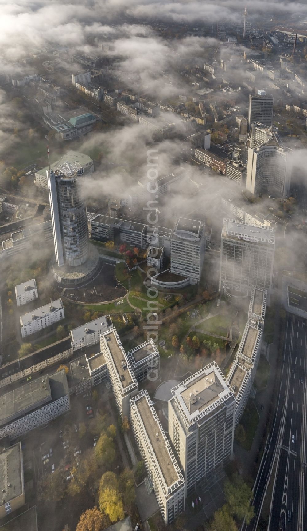 Aerial image Essen - View of the RWE tower shrouded with fog and an impressive cloud bank over the city center of Essen in the state North Rhine-Westphalia. The autumn weather clouds are surrounding the skyscraper headquarters of energy supplier RWE at Opernplatz and form a thick cover over the Ruhr region city