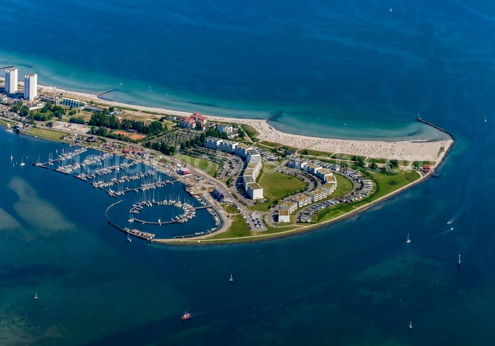 Fehmarn from the bird's eye view: Sandy beach landscape with holiday homes and marina in Burgtiefe on Fehmarn in the state Schleswig-Holstein, Germany