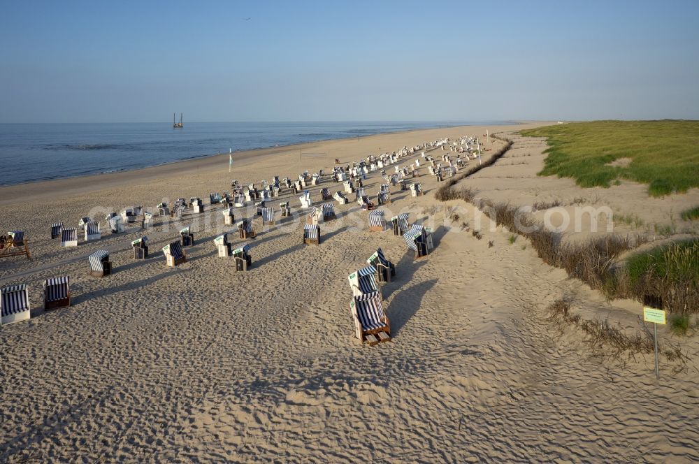 Norderney from the bird's eye view: Sandy beach with beach chair countryside on the North Sea coast of the island of Norderney in Lower Saxony