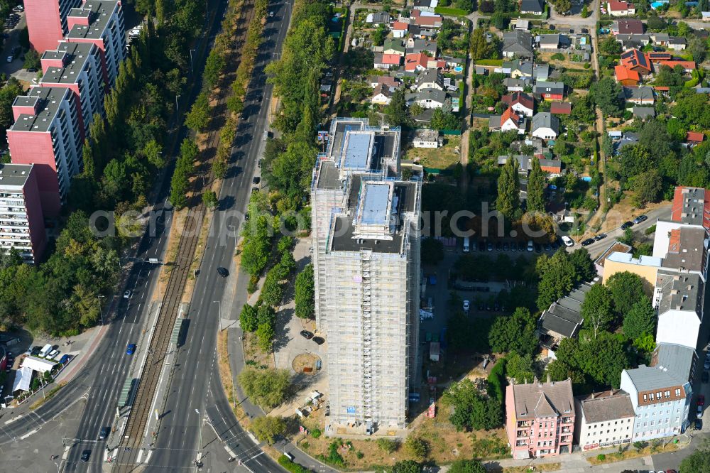 Aerial photograph Berlin - Construction site for the renovation and modernization of the high-rise buildings in the residential area to the low-energy house on street Rhinstrasse in Berlin, Germany