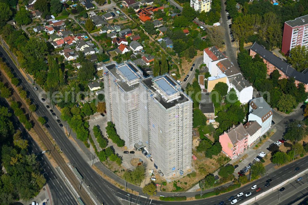 Berlin from above - Construction site for the renovation and modernization of the high-rise buildings in the residential area to the low-energy house on street Rhinstrasse in Berlin, Germany