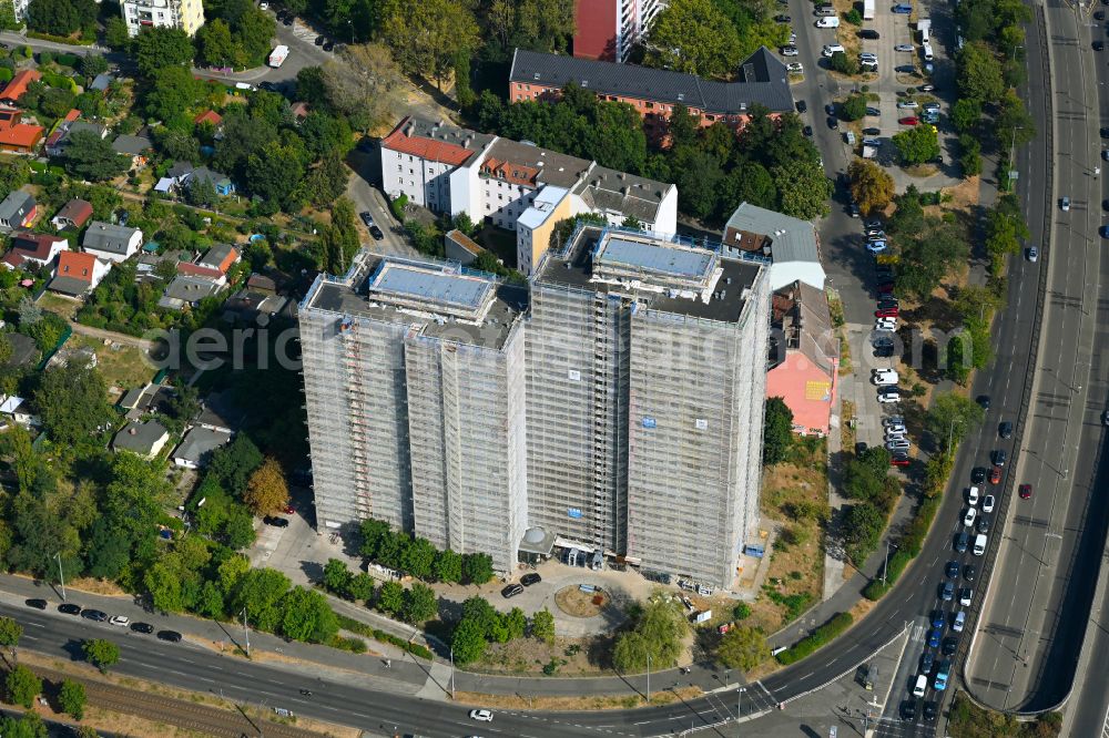 Berlin from the bird's eye view: Construction site for the renovation and modernization of the high-rise buildings in the residential area to the low-energy house on street Rhinstrasse in Berlin, Germany