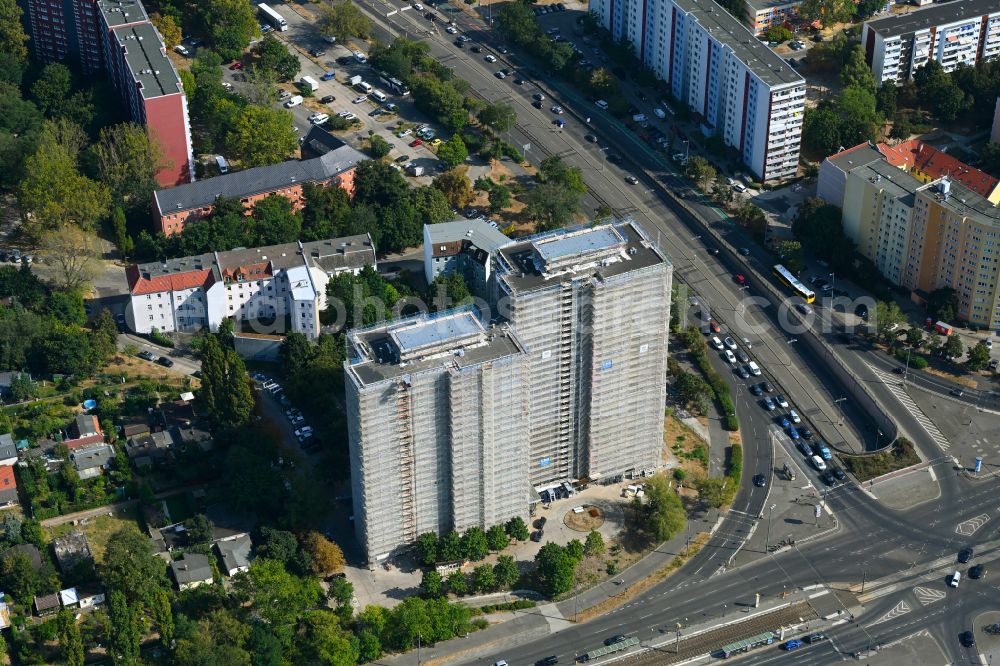 Aerial image Berlin - Construction site for the renovation and modernization of the high-rise buildings in the residential area to the low-energy house on street Rhinstrasse in Berlin, Germany