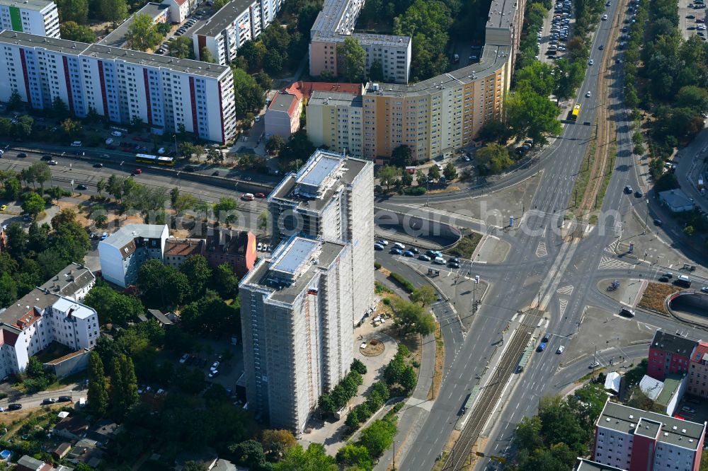 Aerial photograph Berlin - Construction site for the renovation and modernization of the high-rise buildings in the residential area to the low-energy house on street Rhinstrasse in Berlin, Germany