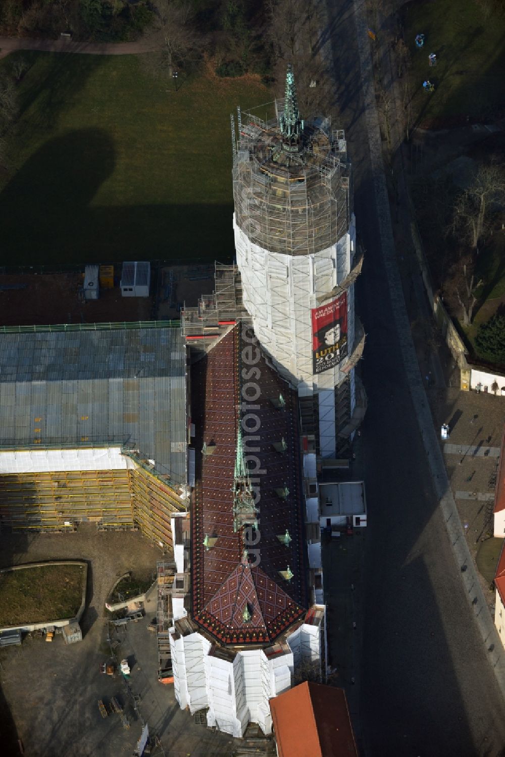 Wittenberg from the bird's eye view: View of the castle church of Wittenberg. The castle with its 88 m high Gothic tower at the west end of the town is a UNESCO World Heritage Site. The first mention of the castle dates from 1187. It gained fame as in 1517 the Wittenberg Augustinian monk and theology professor Martin Luther spread his 95 disputation