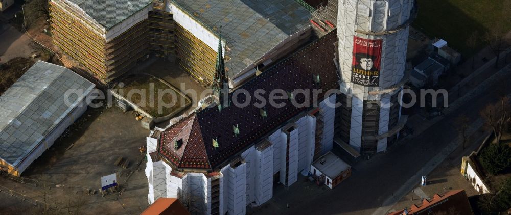 Aerial photograph Wittenberg - View of the castle church of Wittenberg. The castle with its 88 m high Gothic tower at the west end of the town is a UNESCO World Heritage Site. The first mention of the castle dates from 1187. It gained fame as in 1517 the Wittenberg Augustinian monk and theology professor Martin Luther spread his 95 disputation
