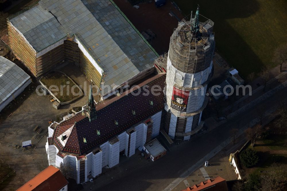 Aerial photograph Wittenberg - View of the castle church of Wittenberg. The castle with its 88 m high Gothic tower at the west end of the town is a UNESCO World Heritage Site. The first mention of the castle dates from 1187. It gained fame as in 1517 the Wittenberg Augustinian monk and theology professor Martin Luther spread his 95 disputation