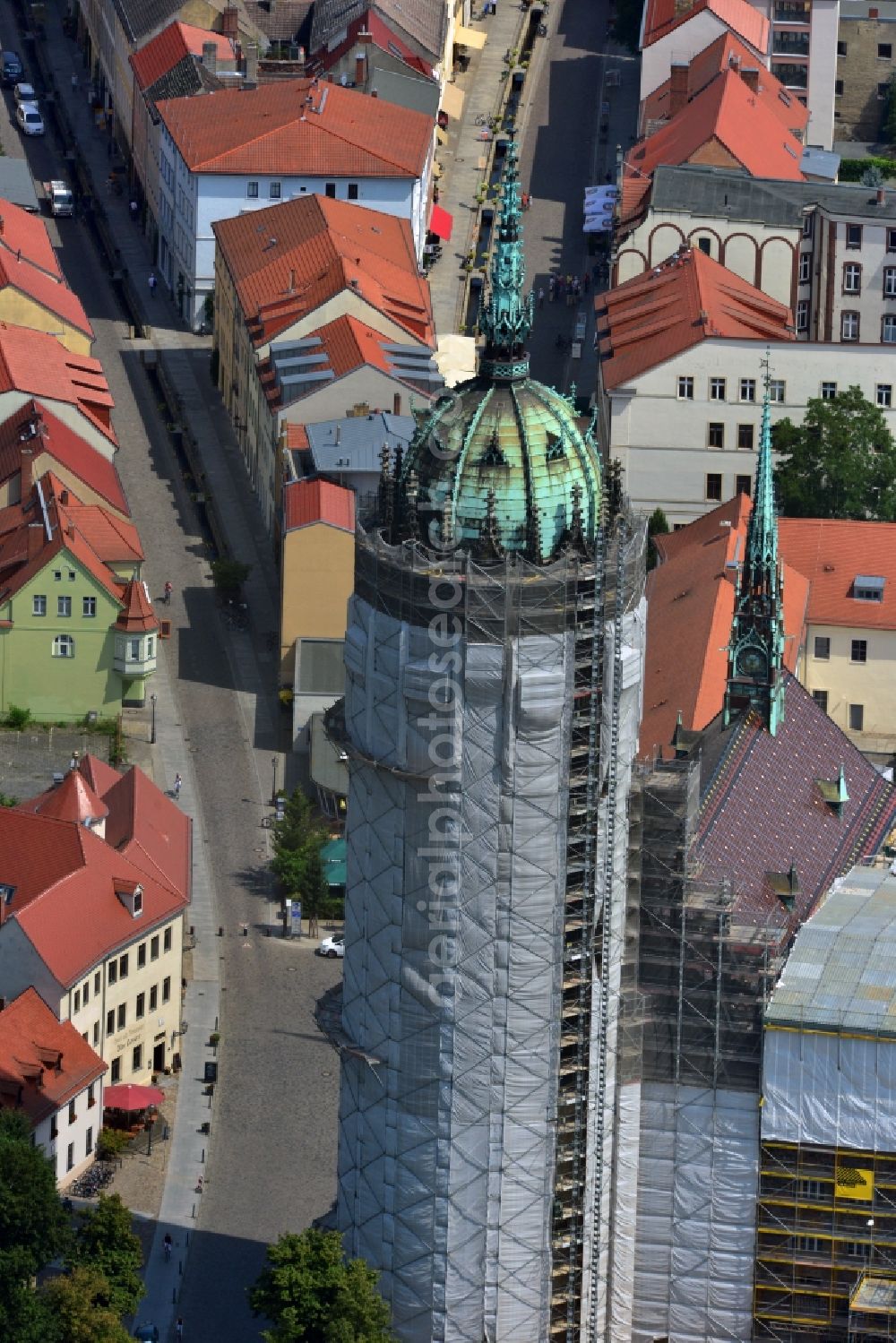 Wittenberg from the bird's eye view: View of the castle church of Wittenberg. The castle with its 88 m high Gothic tower at the west end of the town is a UNESCO World Heritage Site. The first mention of the castle dates from 1187. It gained fame as in 1517 the Wittenberg Augustinian monk and theology professor Martin Luther spread his 95 disputation