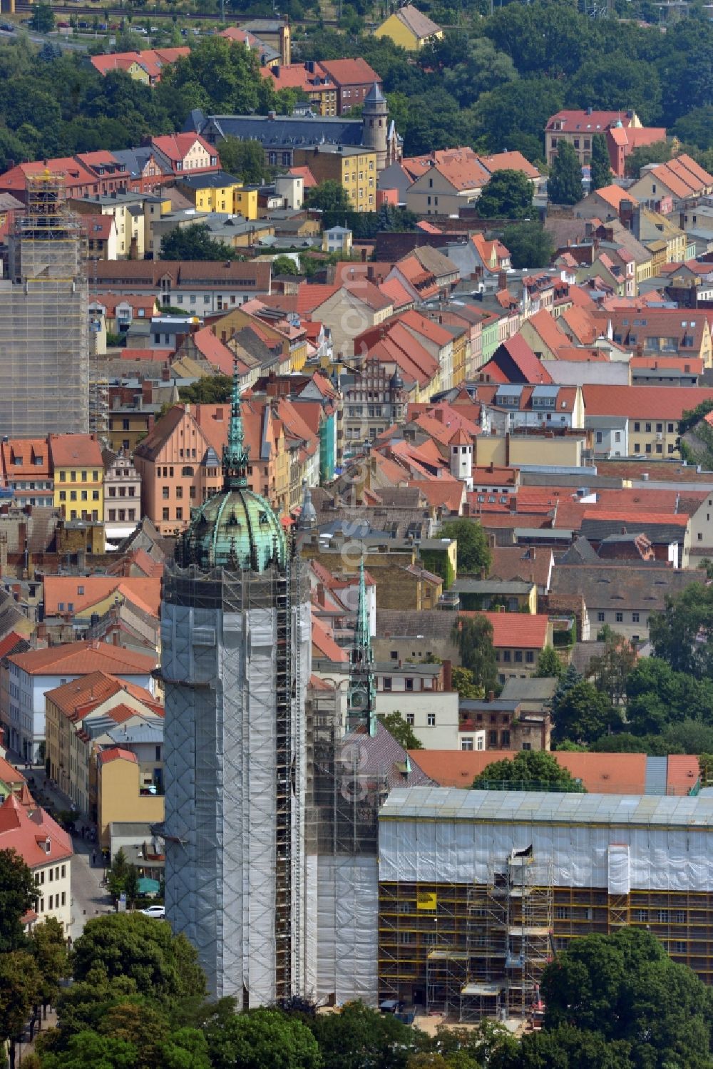 Aerial photograph Wittenberg - View of the castle church of Wittenberg. The castle with its 88 m high Gothic tower at the west end of the town is a UNESCO World Heritage Site. The first mention of the castle dates from 1187. It gained fame as in 1517 the Wittenberg Augustinian monk and theology professor Martin Luther spread his 95 disputation