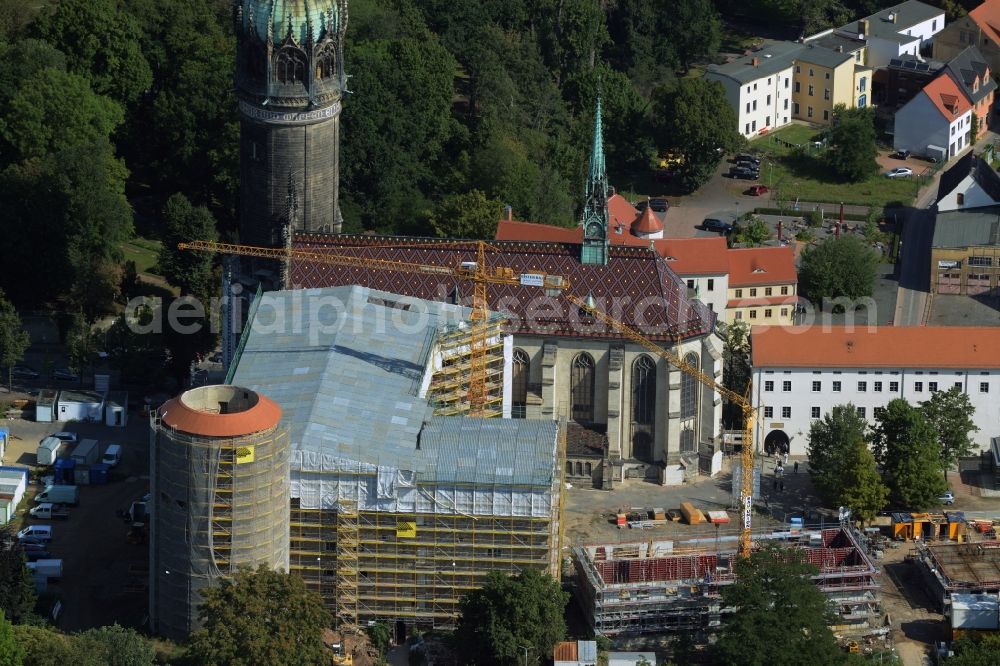 Aerial photograph Lutherstadt Wittenberg - View of the castle church of Wittenberg. The castle with its 88 m high Gothic tower at the west end of the town is a UNESCO World Heritage Site. It gained fame as the Wittenberg Augustinian monk and theology professor Martin Luther spread his disputation