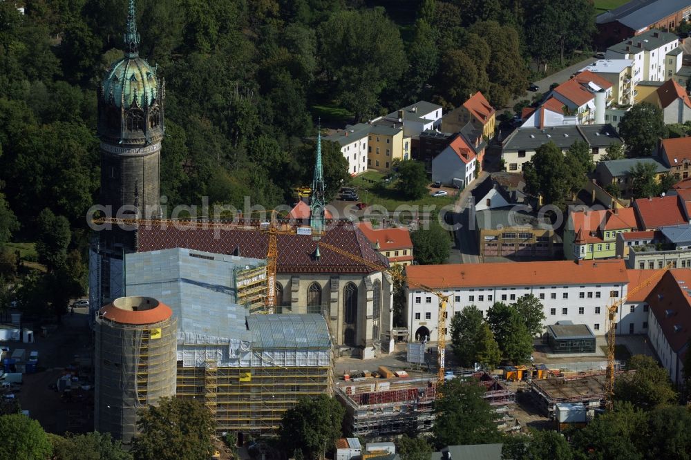 Lutherstadt Wittenberg from above - View of the castle church of Wittenberg. The castle with its 88 m high Gothic tower at the west end of the town is a UNESCO World Heritage Site. It gained fame as the Wittenberg Augustinian monk and theology professor Martin Luther spread his disputation