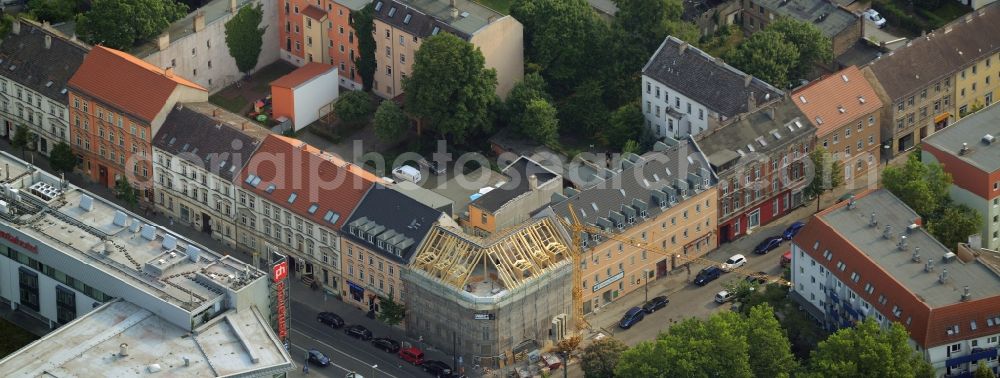 Aerial image Berlin - Renovation and construction site on Koellnischer Platz square in the Koepenick part of Berlin in Germany. A historic corner house with apartments and business space in a building complex is scaffolded and being refurbished. Tram tracks, a hotel and historic buildings are located on the square