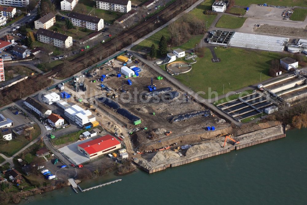 Grenzach-Wyhlen from the bird's eye view: Remediation at the site of the former wastewater treatment plant of the pharmaceutical company Roche in Grenzach-Wyhlen in Baden -Wuerttemberg. Construction of a temporary landing stage on the river Rhine for the removal of the excavated material