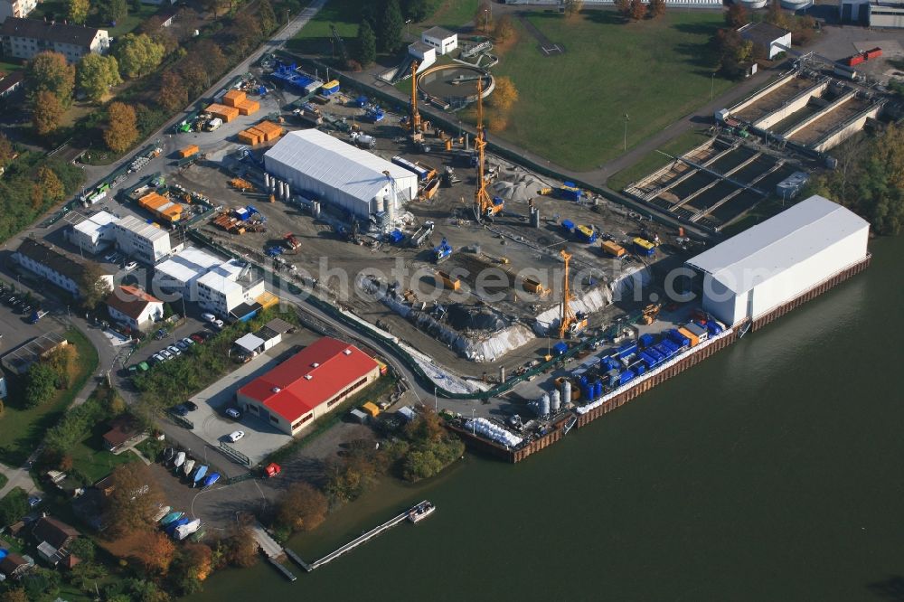 Grenzach-Wyhlen from the bird's eye view: Remediation at the site of the former wastewater treatment plant of the pharmaceutical company Roche in Grenzach-Wyhlen in Baden -Wuerttemberg. The temporary landing stage on the river Rhine is used for the removal of the excavated material