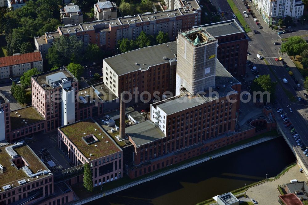 Aerial image Berlin Tempelhof - Renovation work on the scaffolded clock tower of the Ullstein House of Becker & Kries group at Tempelhof harbor in Berlin