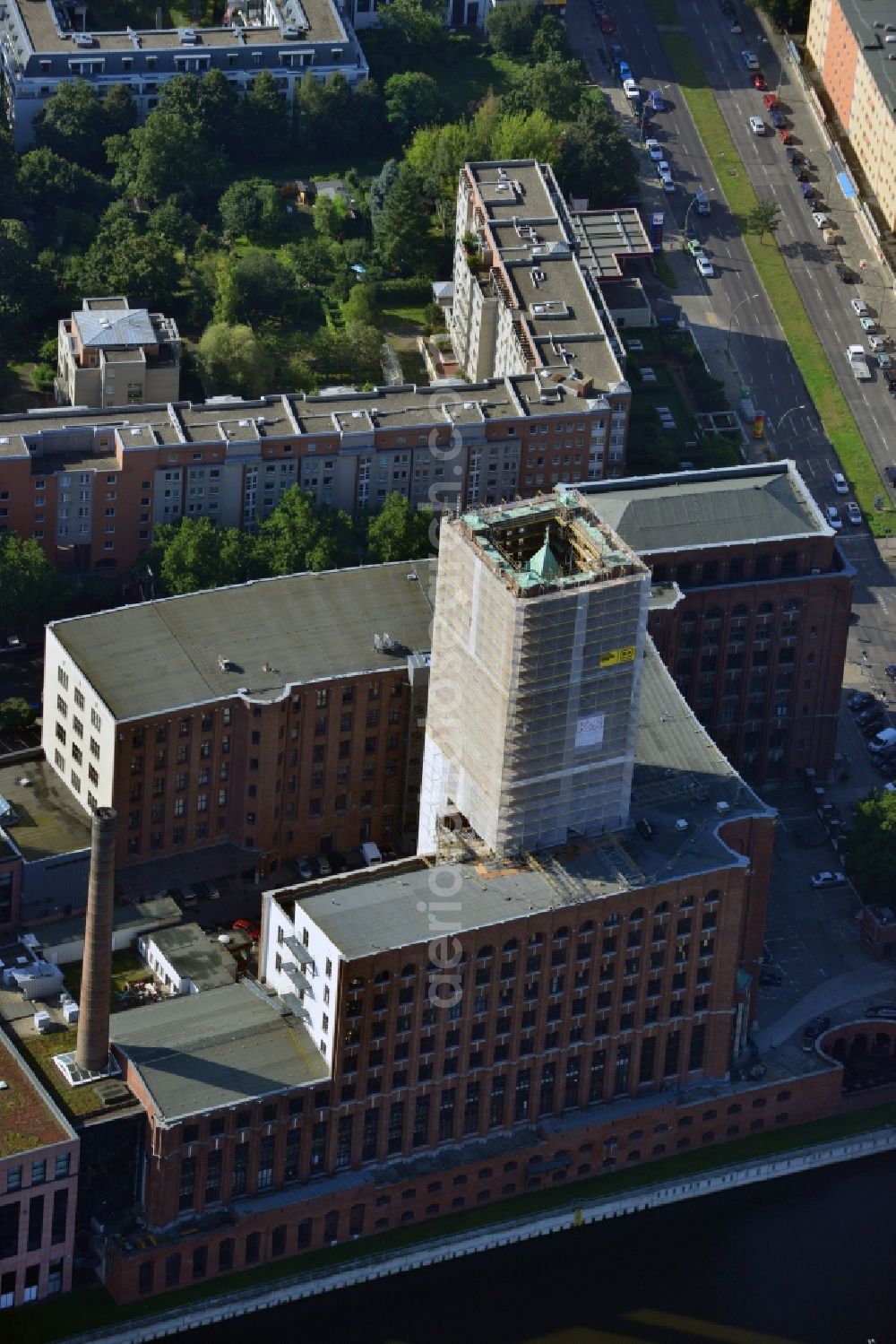 Aerial photograph Berlin Tempelhof - Renovation work on the scaffolded clock tower of the Ullstein House of Becker & Kries group at Tempelhof harbor in Berlin