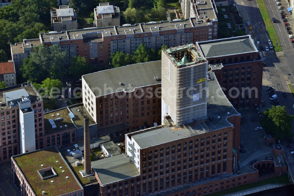 Berlin Tempelhof from above - Renovation work on the scaffolded clock tower of the Ullstein House of Becker & Kries group at Tempelhof harbor in Berlin