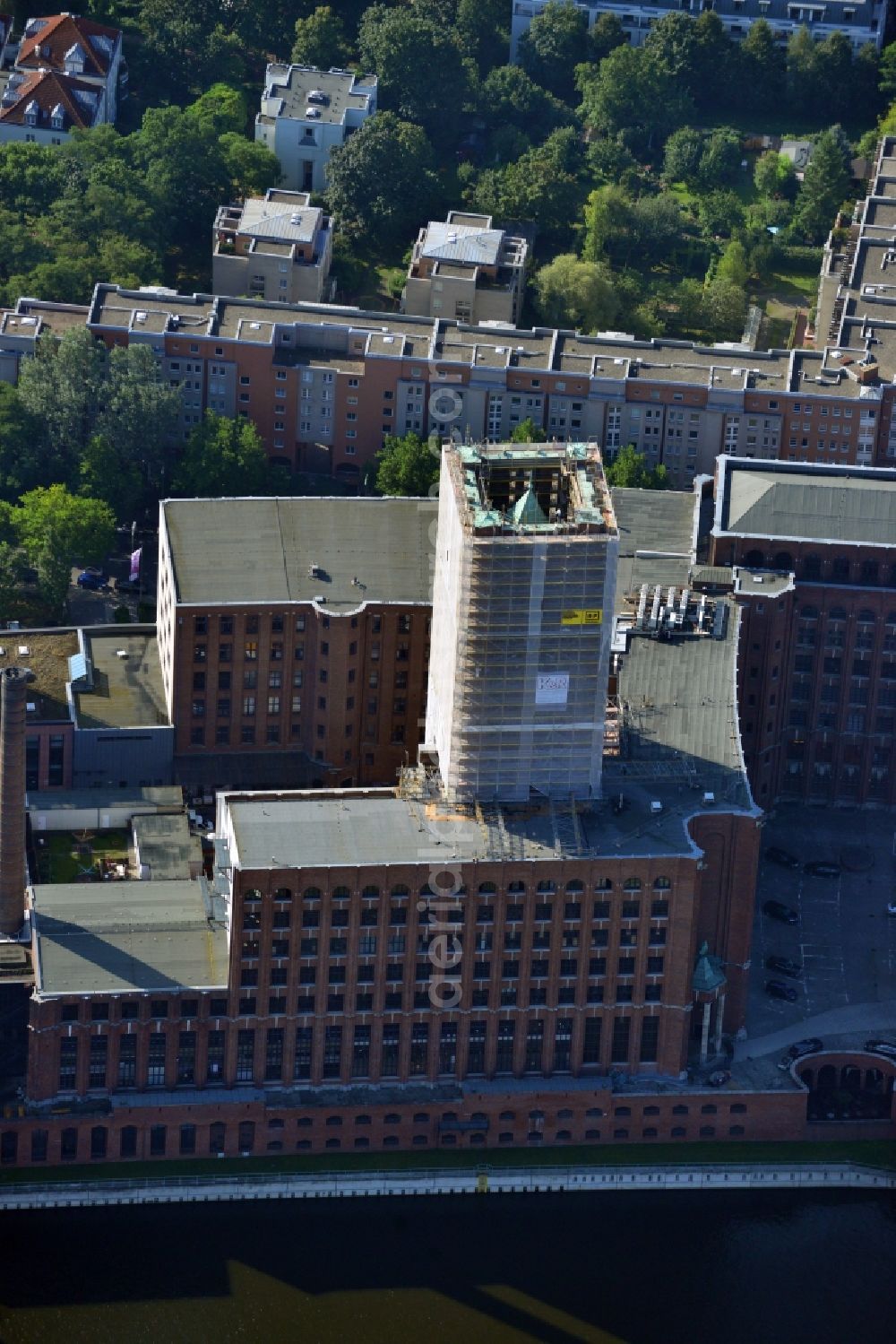 Berlin Tempelhof from the bird's eye view: Renovation work on the scaffolded clock tower of the Ullstein House of Becker & Kries group at Tempelhof harbor in Berlin