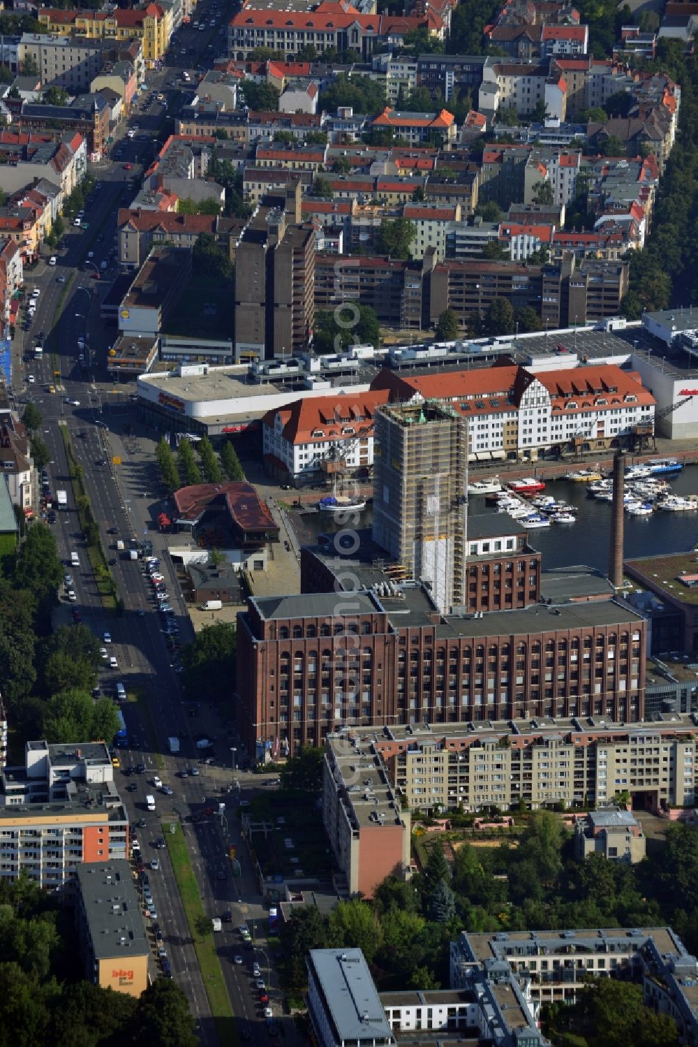 Berlin Tempelhof from the bird's eye view: Renovation work on the scaffolded clock tower of the Ullstein House of Becker & Kries group at Tempelhof harbor in Berlin