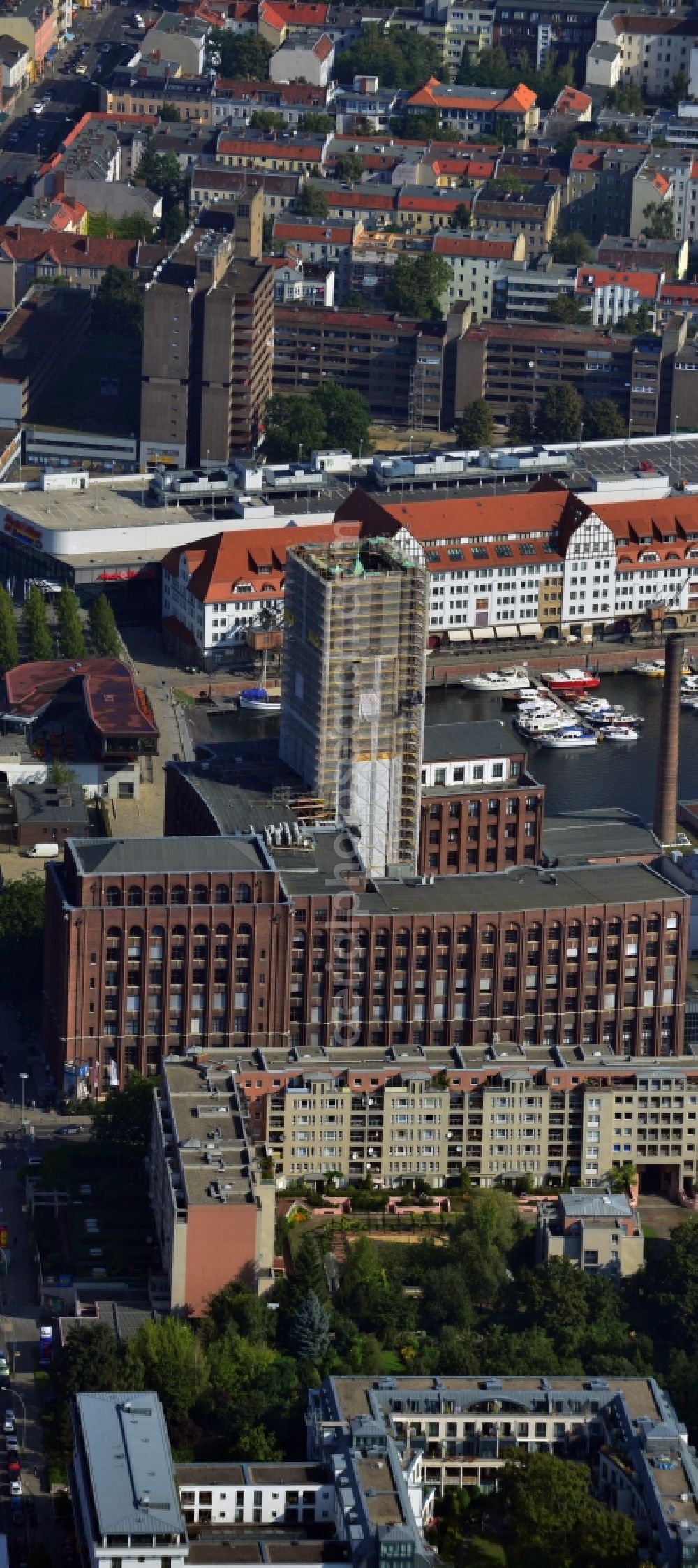 Aerial image Berlin Tempelhof - Renovation work on the scaffolded clock tower of the Ullstein House of Becker & Kries group at Tempelhof harbor in Berlin