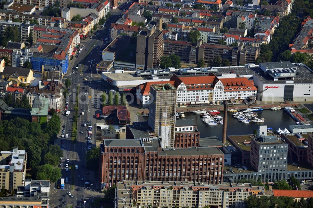 Aerial photograph Berlin Tempelhof - Renovation work on the scaffolded clock tower of the Ullstein House of Becker & Kries group at Tempelhof harbor in Berlin