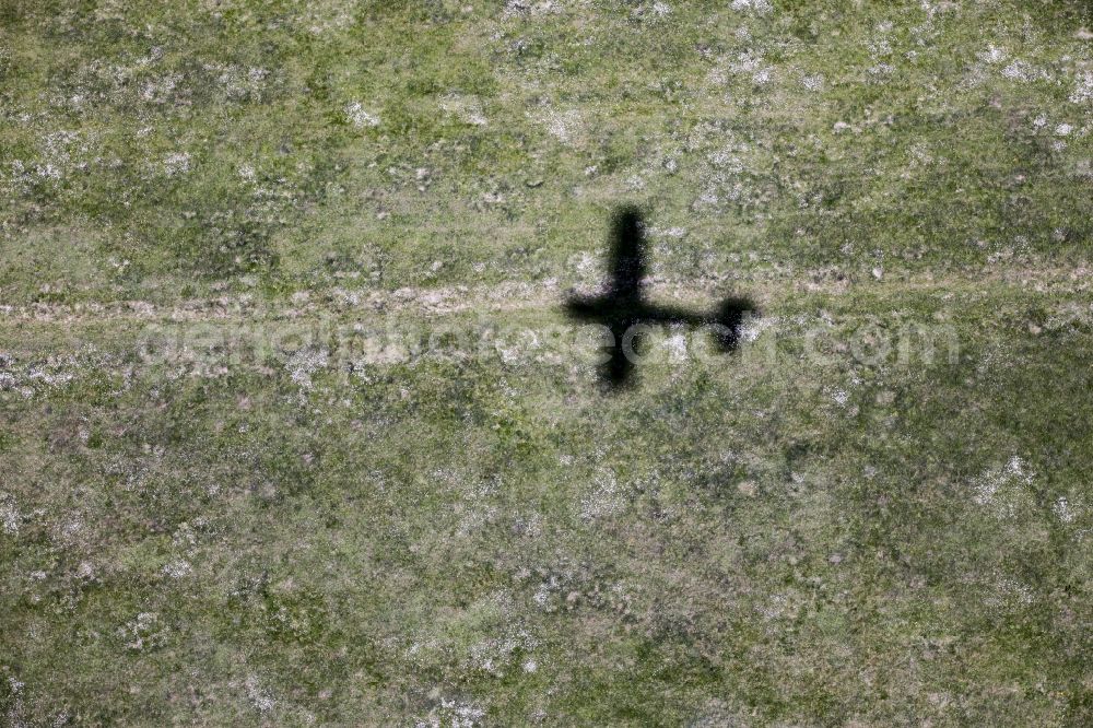 Aerial image Werneuchen - Shadow of the Cessna 172 D-EGYC of euroluftbild.de on grass at the airfield in Werneuchen in the state of Brandenburg