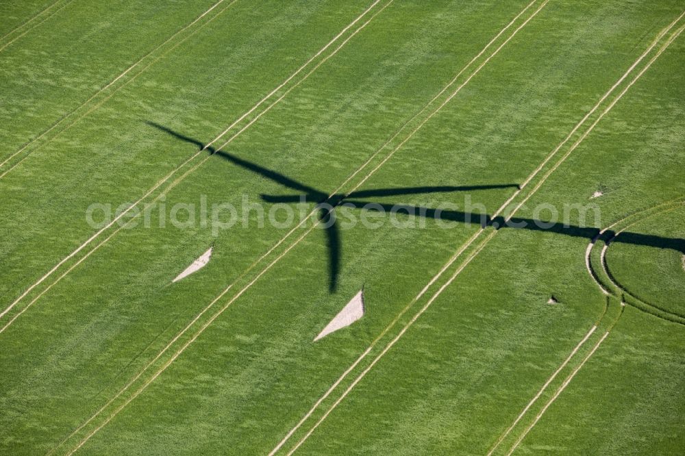 Aerial photograph Werneuchen - Shadow of a wind turbine - wheel - on a field in Werneuchen in the state of Brandenburg