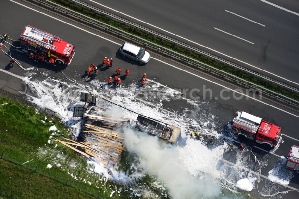 Aerial photograph Hollenstedt - Foam carpet-fighting operations of a fire department in a truck-fire-fire on the motorway Autobahn A1 - E22 at Hollenstedt in the state of Lower Saxony