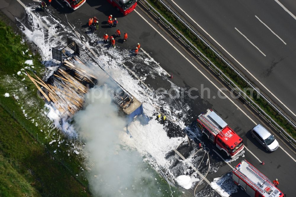 Hollenstedt from above - Foam carpet-fighting operations of a fire department in a truck-fire-fire on the motorway Autobahn A1 - E22 at Hollenstedt in the state of Lower Saxony