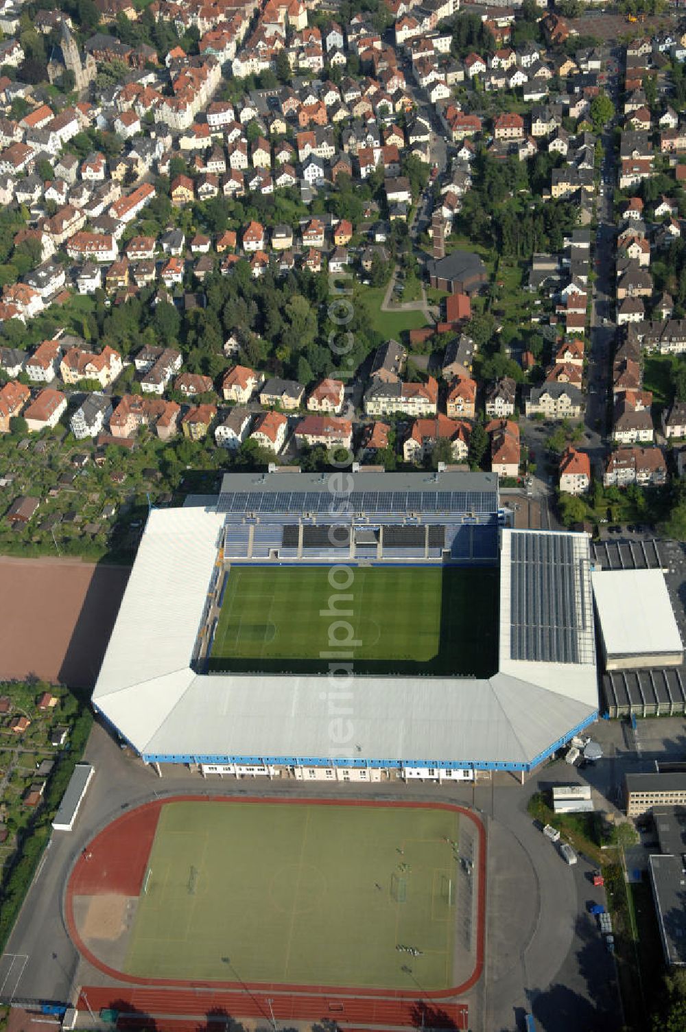 Aerial image Bielefeld - Die Schüco Arena, auch Bielefelder Alm oder Alm-Stadion genannt, im Grundbuch eingetragen als Stadion an der Melanchthonstraße, ist die Wettkampfstätte des Deutschen Sportclubs Arminia Bielefeld. Das Stadion an der Melanchthonstraße, dessen Namensrechte am 13. Januar 2004 an die Firma Schüco International KG vergeben wurden, bietet 27.300 Zuschauern Platz und ist im Besitz des Vereins, der es ohne öffentliche Zuschüsse betreibt. Kontakt DSC Arminia Bielefeld GmbH & Co. KGaA: Tel. +49(0)521 966 110, Email: kontakt@arminia-bielefeld.de; Kontakt Schüco International KG: Tel. +49(0)521 7830, Email: info@schueco.com