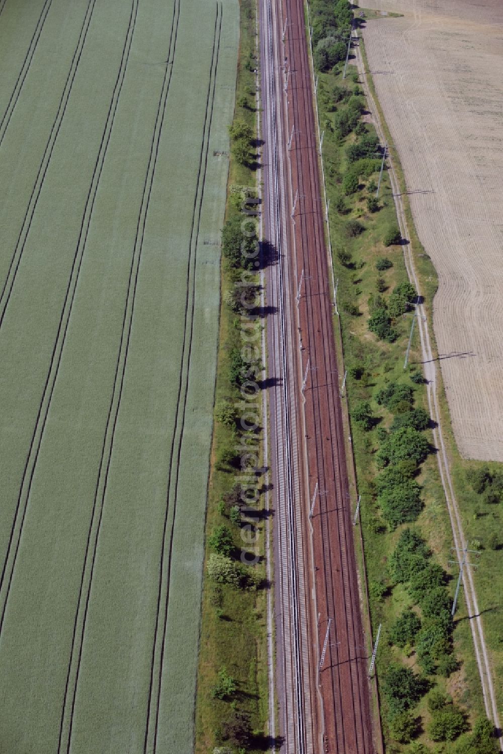 Schönefeld from the bird's eye view: Railway track and overhead wiring harness in the route network of the Deutsche Bahn in Schoenefeld in the state Brandenburg, Germany