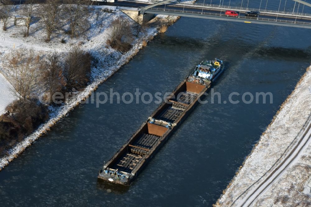 Parey from the bird's eye view: Ship and pushed convoys of inland waterway transport in driving on the winter covered with snow and ice flux flow of the waterway of the Elbe-Havel Canal in Parey in the state of Saxony-Anhalt