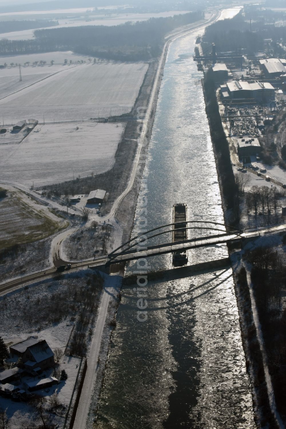 Aerial photograph Parey - Ship and pushed convoys of inland waterway transport in driving on the winter covered with snow and ice flux flow of the waterway of the Elbe-Havel Canal in Parey in the state of Saxony-Anhalt