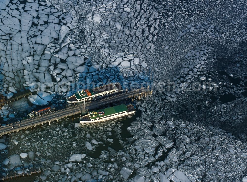 Frauenchiemsee from above - Ships and dock at the island Frauenchiemsee in the lake Chiemsee in the state of Bavaria. The island is car free and reachable via ship throughout the year. The dock is enclosed by ice floe