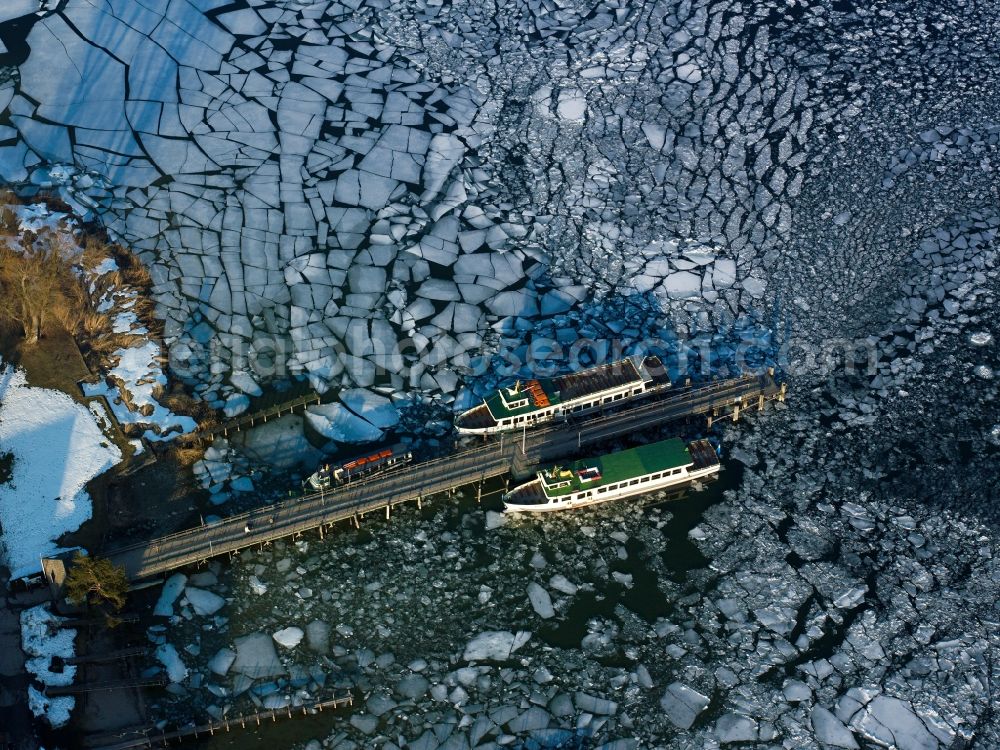 Aerial image Frauenchiemsee - Ships and dock at the island Frauenchiemsee in the lake Chiemsee in the state of Bavaria. The island is car free and reachable via ship throughout the year. The dock is enclosed by ice floe