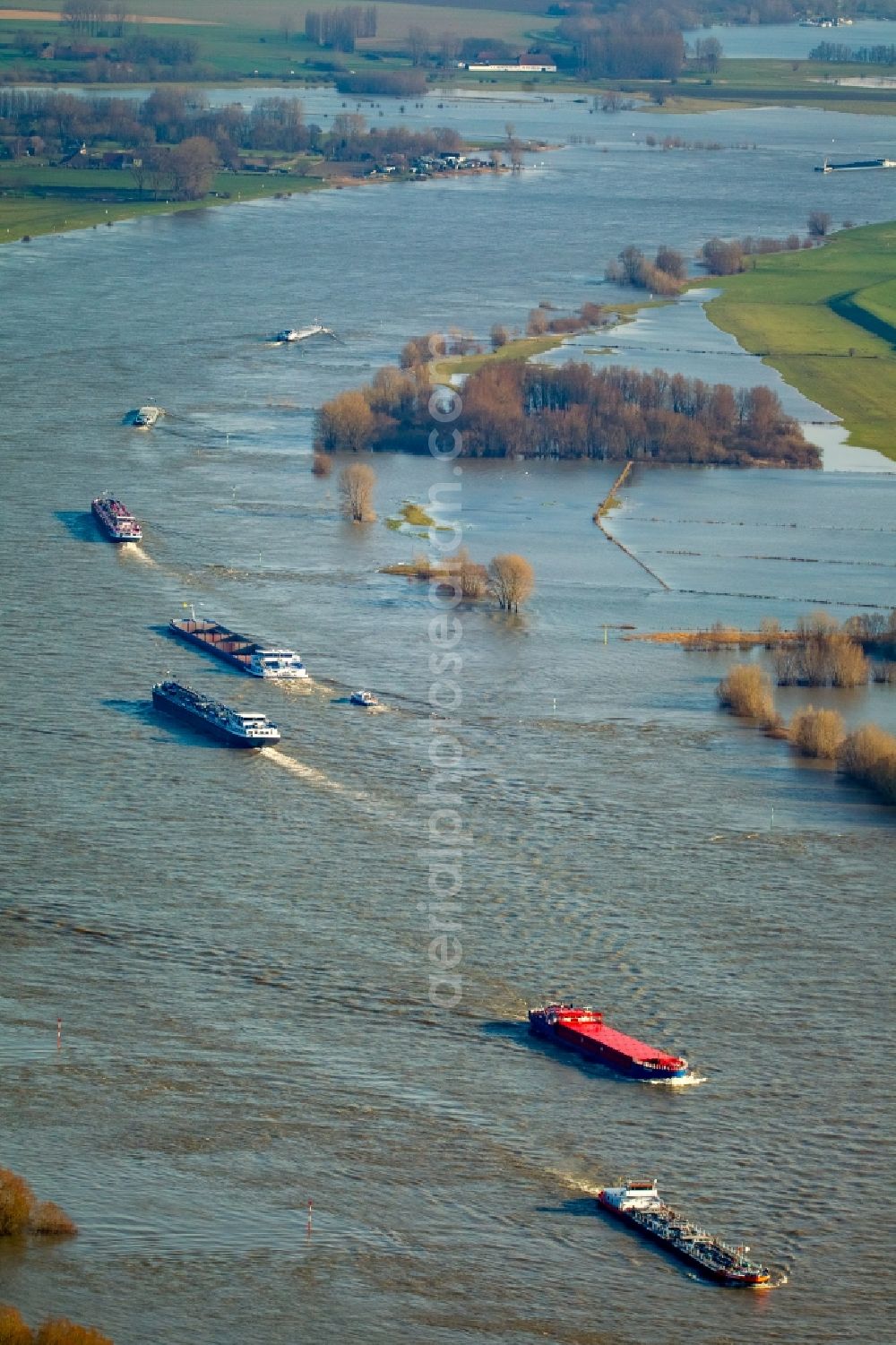 Aerial image Emmerich am Rhein - Ships and barge trains inland waterway transport in driving on the waterway of the river Rhine in Emmerich am Rhein in the state North Rhine-Westphalia