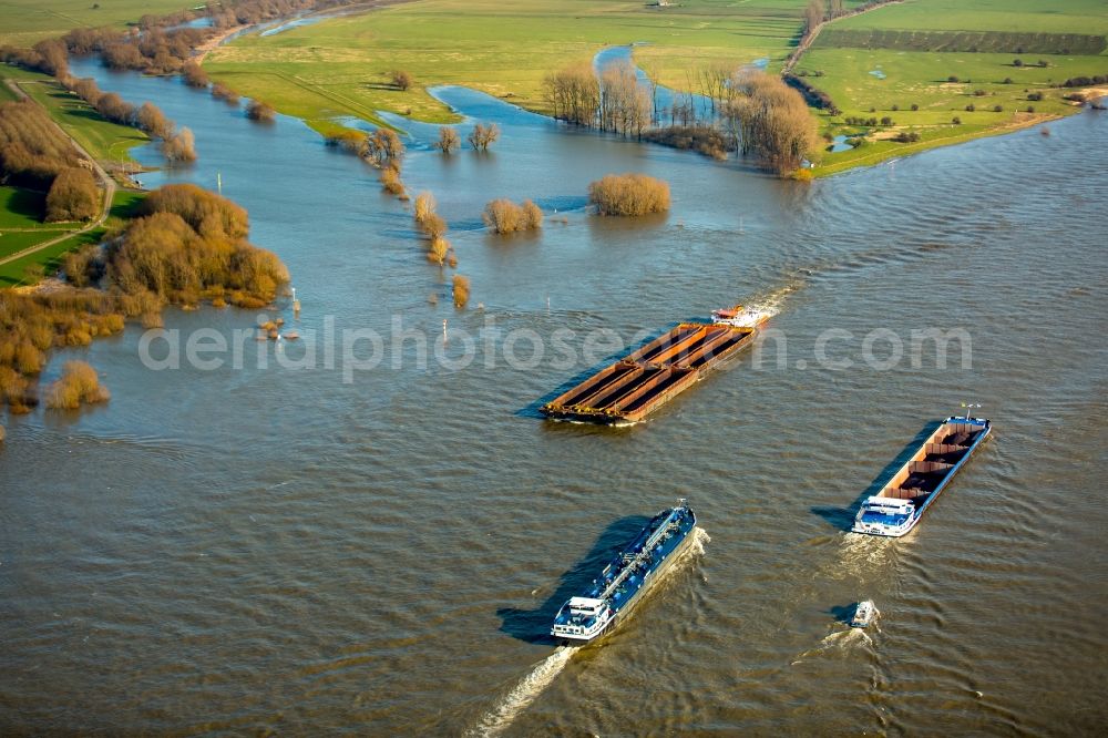 Emmerich am Rhein from above - Ships and barge trains inland waterway transport in driving on the waterway of the river Rhine in Emmerich am Rhein in the state North Rhine-Westphalia