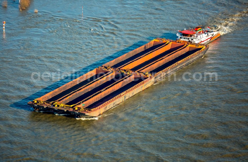 Emmerich am Rhein from the bird's eye view: Ships and barge trains inland waterway transport in driving on the waterway of the river Rhine in Emmerich am Rhein in the state North Rhine-Westphalia