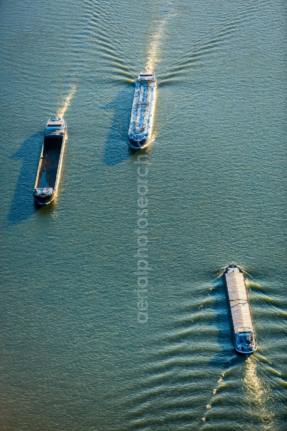 Aerial image Duisburg - Ships and barge trains inland waterway transport in driving on the waterway of the river of rhine in Duisburg in the state North Rhine-Westphalia