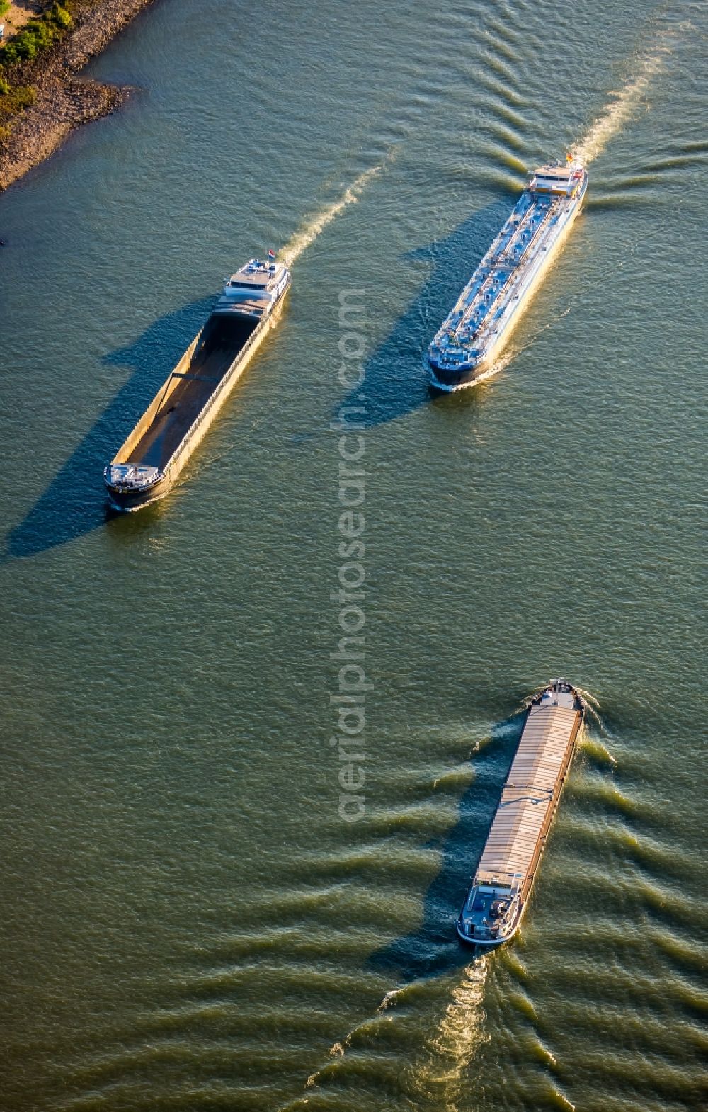 Duisburg from above - Ships and barge trains inland waterway transport in driving on the waterway of the river of rhine in Duisburg in the state North Rhine-Westphalia