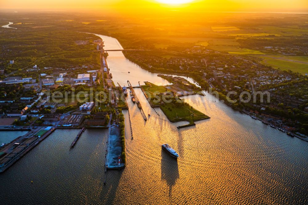 Aerial image Kiel - Lock systems on the bank of Kiel-Holtenau lock island in the morning light with sun rays on the Kiel Canal in Kiel in the state of Schleswig-Holstein