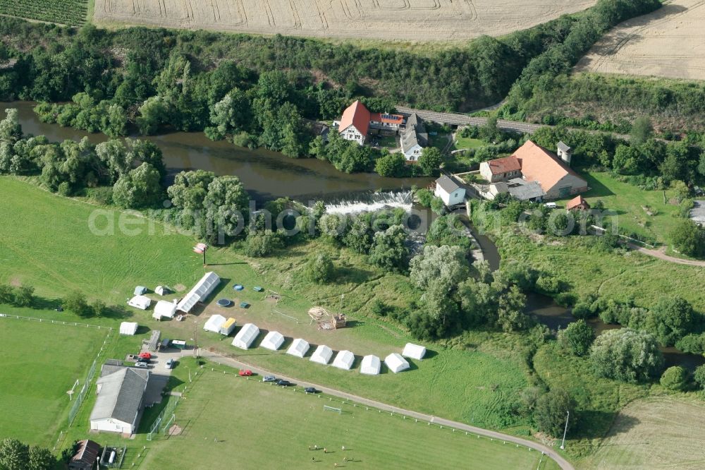 Meddersheim from the bird's eye view: Schliffges Mill in the borough of Meddersheim in the state Rhineland-Palatinate. The borough and municipiality is a village in the county district of Bad Kreuznach. The mill is located on the river Nahe, with a tent camp in the South of it