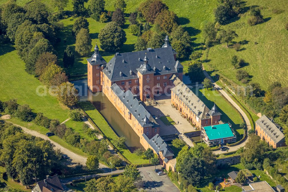 Aerial image Kirchhundem - Castle Adolfsburg in the borough of Kirchhundem in the state of North Rhine-Westphalia. The water castle is located in the Oberhundem part of the borough and was built in the 1670s as a recreational manor. It is renowned for its western front with the two towers. The u-shaped compound also includes an elaborate courtyard and a park