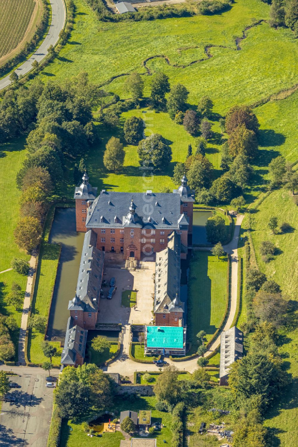 Aerial image Kirchhundem - Castle Adolfsburg in the borough of Kirchhundem in the state of North Rhine-Westphalia. The water castle is located in the Oberhundem part of the borough and was built in the 1670s as a recreational manor. It is renowned for its western front with the two towers. The u-shaped compound also includes an elaborate courtyard and a park