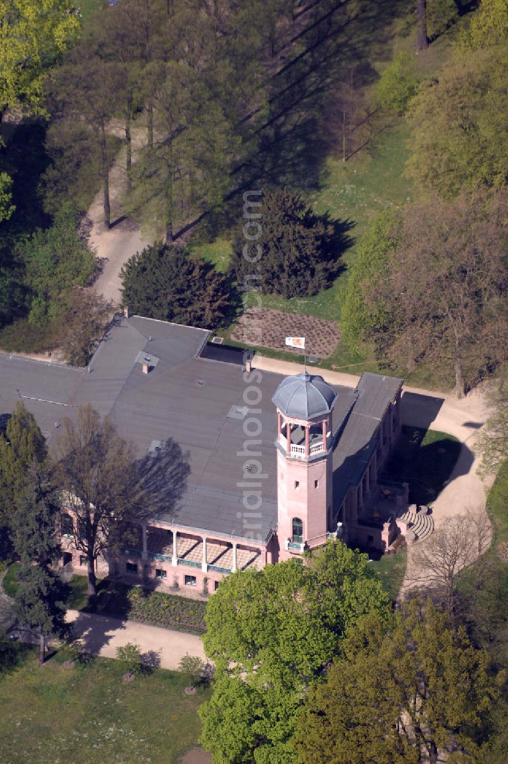 Berlin from the bird's eye view: Es wurde 1868 als spätklassizistische Turmvilla auf dem Gelände eines ehemaligen Rittergutes erbaut. Zu den Besitzern des Schlosses zählten unter an derem Werner und Wilhelm von Siemens. Wilhelm ließ den Schlosspark zwischen 1891 und 1898 auf 14 Hektar erweitern und durch den Gartenarchitekten Albert Brodersen als Landschaftspark gestalten. Das Schloss, dem die Architekten Martin Gropius, Heino Schmieden und später Theodor Astfalck sein einst markantes Aussehen verliehen, ging 1927 in den Besitz der Stadt Berlin über und ist seitdem einer stetigen Vernachlässigung ausgesetzt worden. Ein Brand im Jahre 1945 vernichtete das Obergeschoss, das bislang nicht wieder aufgebaut wurde. Seit 1979 stehen der alte Herrensitz, der Schlosspark und der historische Biesdorfer Ortskern unter Denkmalschutz. Als besonderes Schutzgut gilt die für den Berliner Raum einmalige Fassadenausführung in eingefärbtem Romanzementmörtel (Kunststeinfassade, ausgeführt durch den Stukkateurmeister H.Beyerhaus, Berlin, als „meine erste Fassade in Zementguß“). Das Biesdorfer Schloss wurde in den vergangenen Jahren und Jahrzehnten als Freizeiteinrichtung und seit 1994 als sozial-kulturelles Zentrum genutzt.