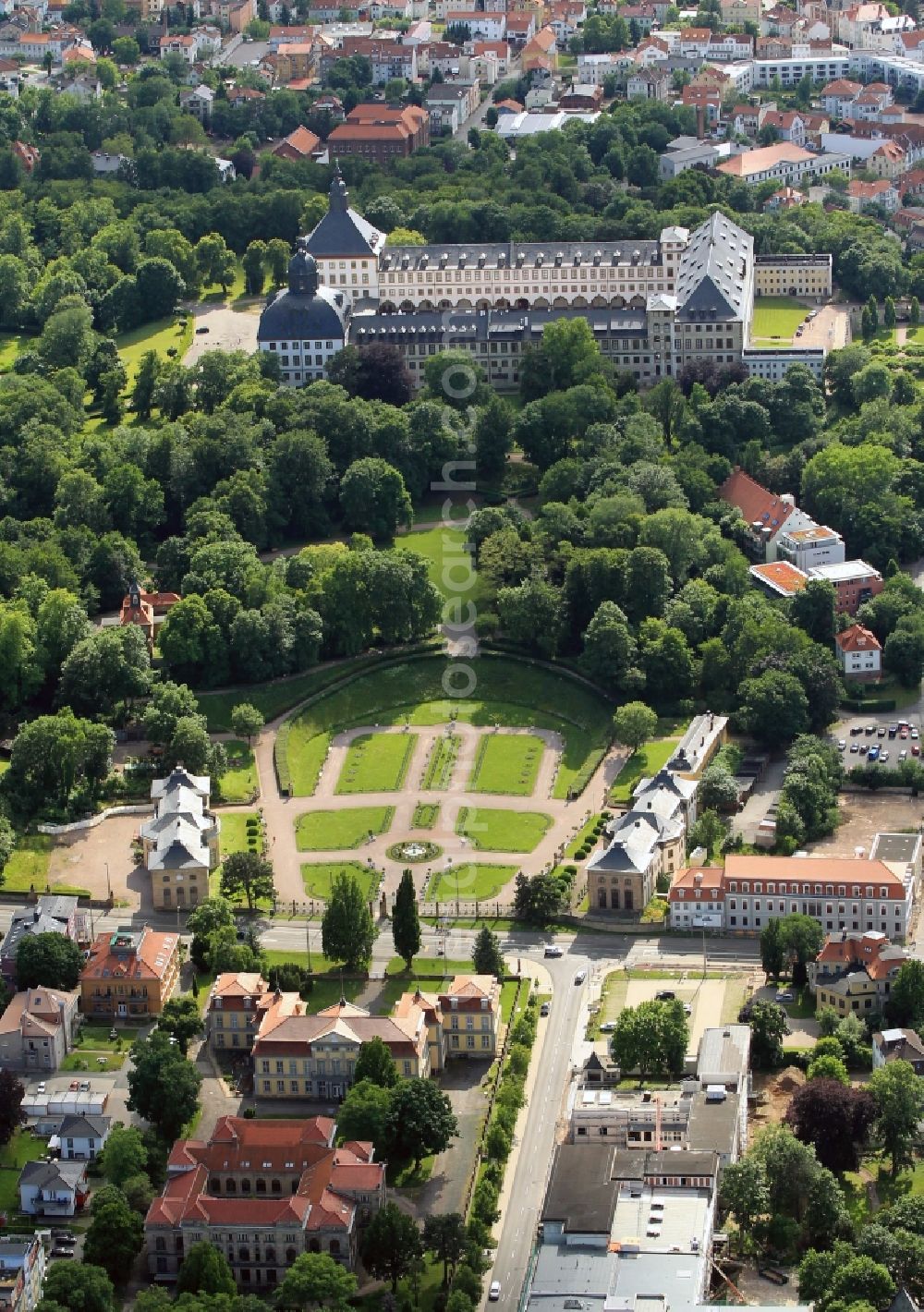 Gotha from the bird's eye view: The major attraction of Gotha in Thuringia is Castle Friedenstein. The building complex of the castle several museums and cultural institutions are housed. The early Baroque castle was built by architect Caspar Vogel. The Baroque Affiliate park with the two buildings is the orangery of the castle Friedenstein. Palace and Park Friedenstein be managed by the Stiftung Schloss Friedenstein Gotha. In the foreground castle Friedrichsthal is to see to what today is the State Vocational School of Construction, Economics and Transport