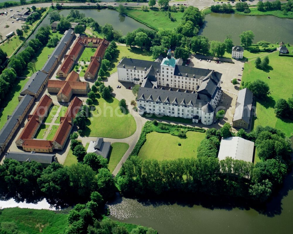 Schleswig from the bird's eye view: Castle Gottorf in the Southwest of the city of Schleswig in the state of Schleswig-Holstein. The castle is an important building of the state. Throughout its 800 year history it was reconverted from a middle age fortress to a renaissance fortress and finally a baroque castle. It is located on the castle island, close to the castle lake and is the largest castle of the state. Part of the compound are impressive gardens and parks