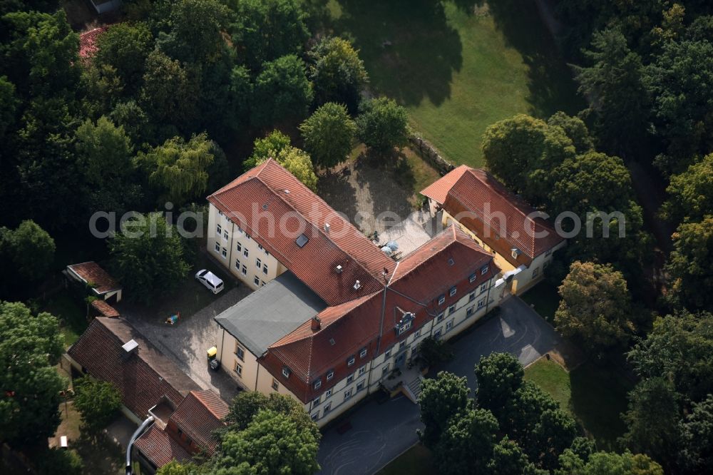 Aerial photograph Grüningen - Care facility Castle Grueningen in the East of Grueningen in the state of Thuringia. The care facility is being run by Novalis Diakonie as Castle Sophie von Kuehn and is located in a forest on the Eastern edge of the village