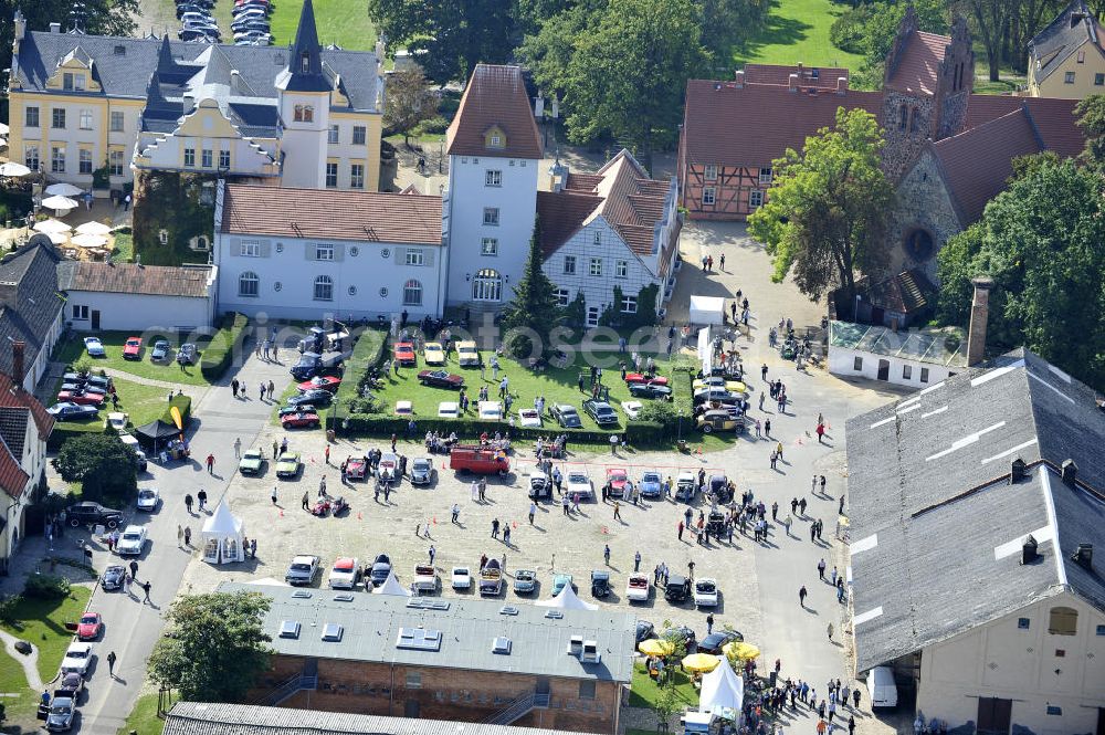 LIEBENBERG from the bird's eye view: Blick auf das Schloss & Gut Liebenberg. Das Schloss Liebenberg wurde 1745 erbaut und später durch Theodor Fontane beschrieben. Es umfasst neben dem Herrenhaus Gutsanlagen und einen Landschaftspark nach Entwürfen von Peter Joseph Lenné. Der Gebäudekomplex wurde durch die DKB Stiftung Liebenberg gemeinnützige GmbH originalgetreu und liebevoll restauriert, einschließlich der Feldsteinkirche und dem Inspektorenhaus mit Kaiserbrunnen. View of the areal of Castle Liebenberg.